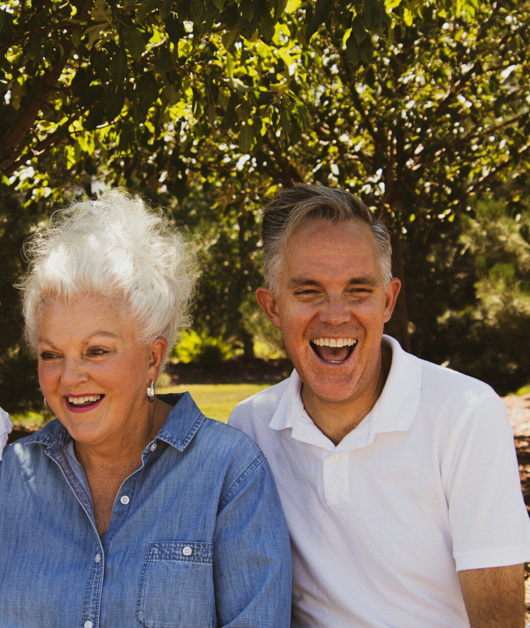 Active senior couple walking and laughing outdoors