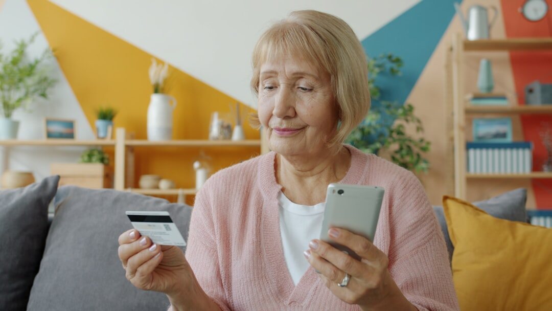 Senior woman using a discount card while shopping