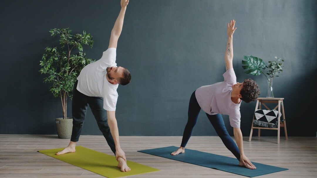 Seniors practicing yoga together in a bright room